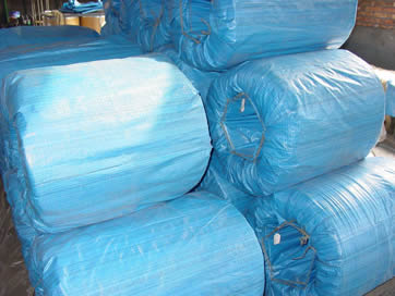 A large coil of PC wire is covered with hessian bag.